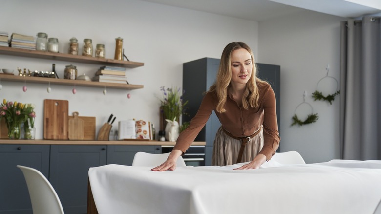 a woman sets a table