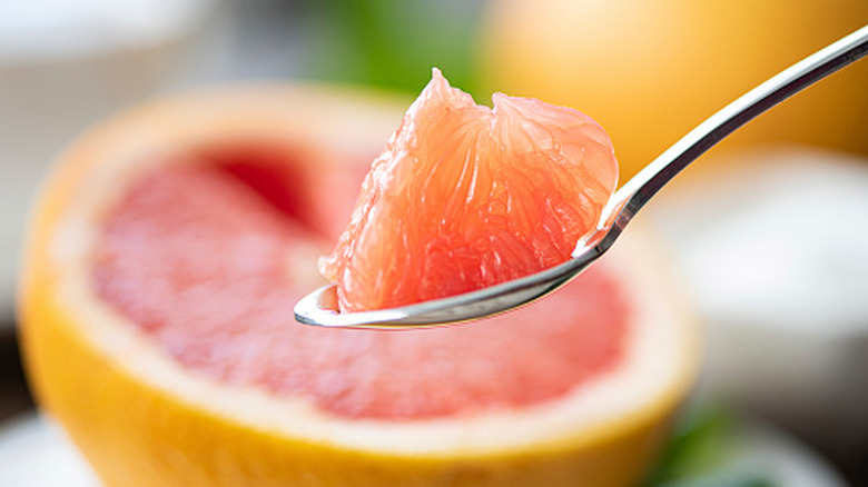 Segment of grapefruit on a teaspoon