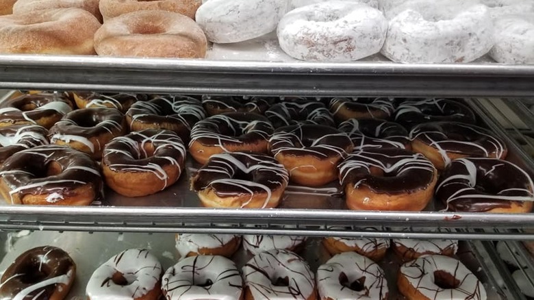 Baking racks of freshly iced donuts