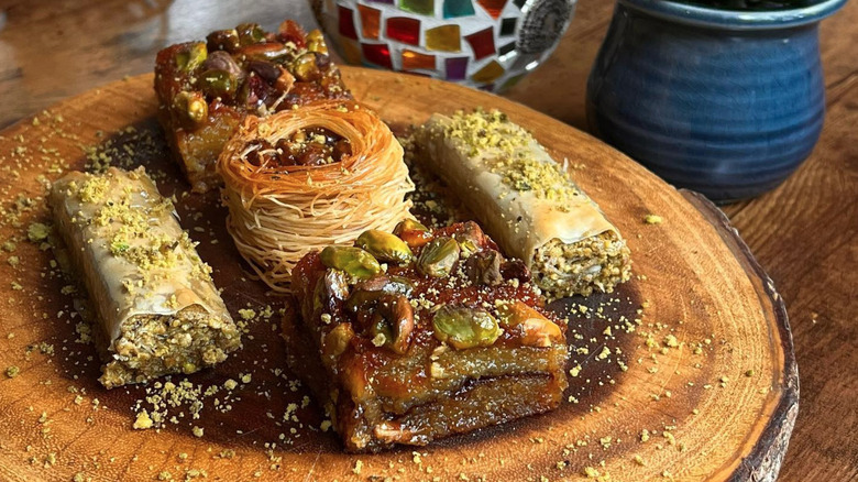 Cross section of log with assortment of baked goods including baklava and bird's nest