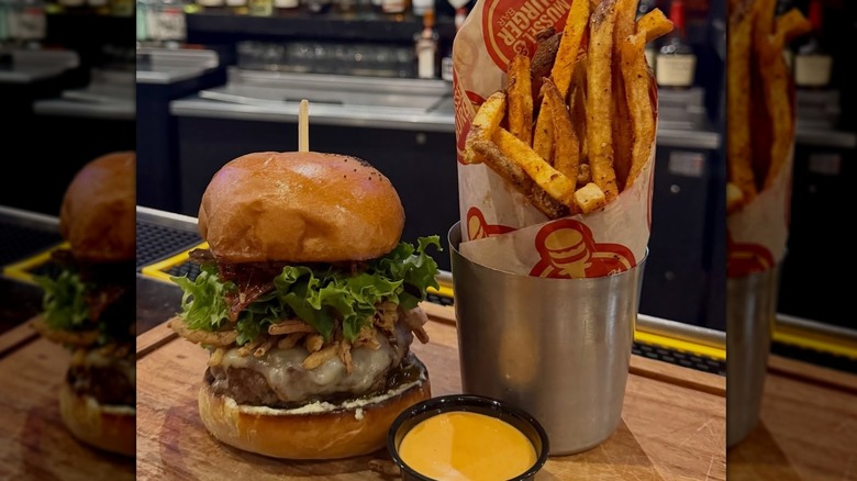A stacked burger and fries from Mussel & Burger Bar in Kentucky