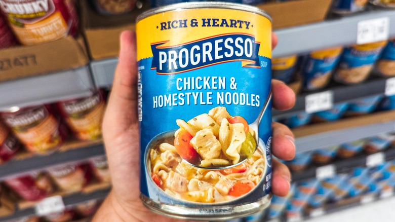 hand holding progresso chicken noodle soup