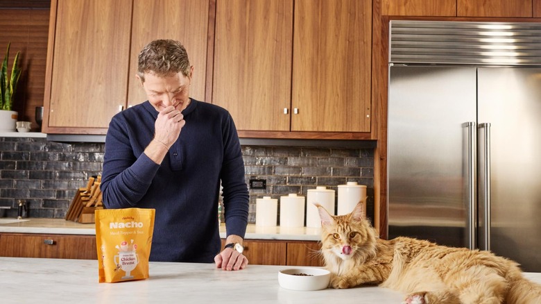 bobby flay and his cat in his kitchen