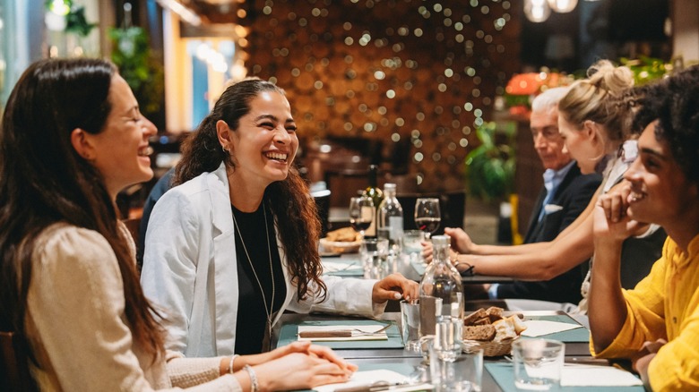 friends sit down for dinner at an italian restaurant