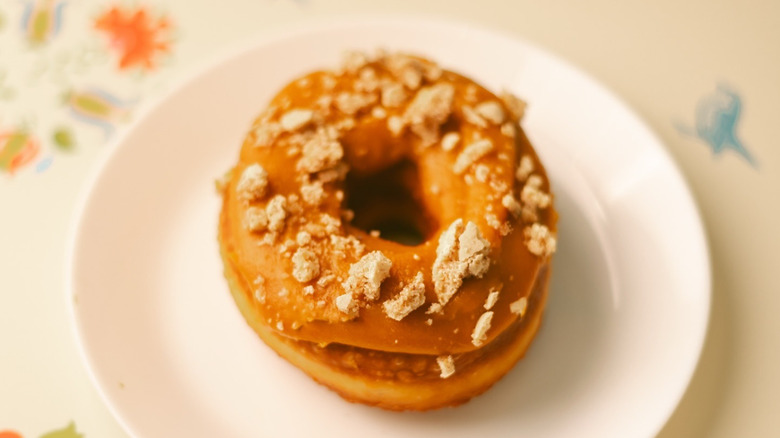 Plate with donut with cookie crumble