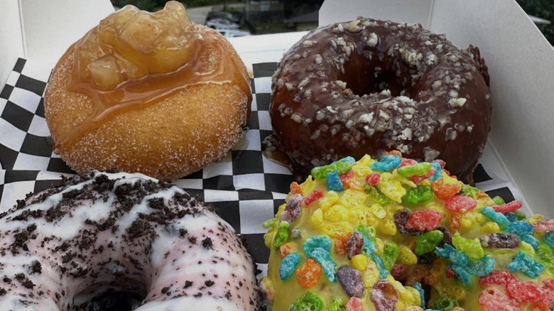 Box of four different donuts outside