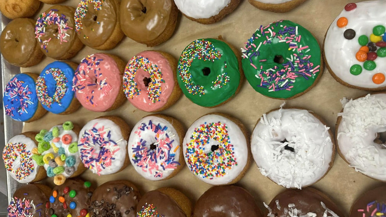 Selection of freshly glazed and decorated donuts