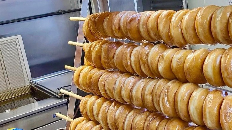 Freshly glazed donuts cooling on racks