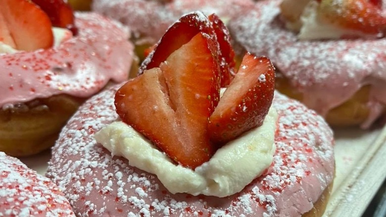 Strawberry cheesecake donuts on baking sheet