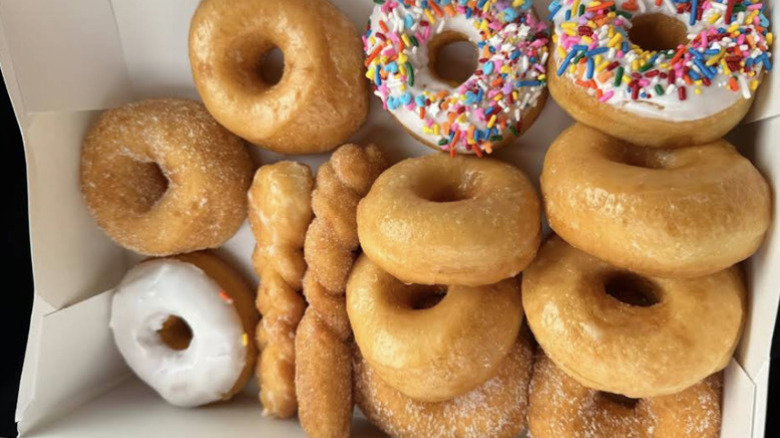 Box of fresh glazes and sprinkle donuts