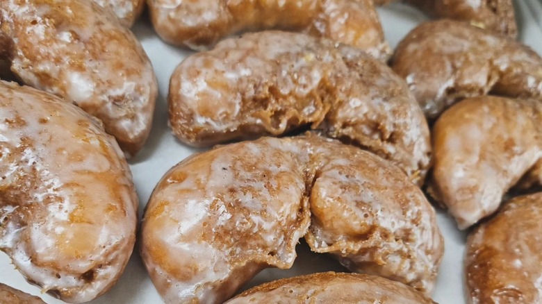 Freshly glazed crescent shaped donuts