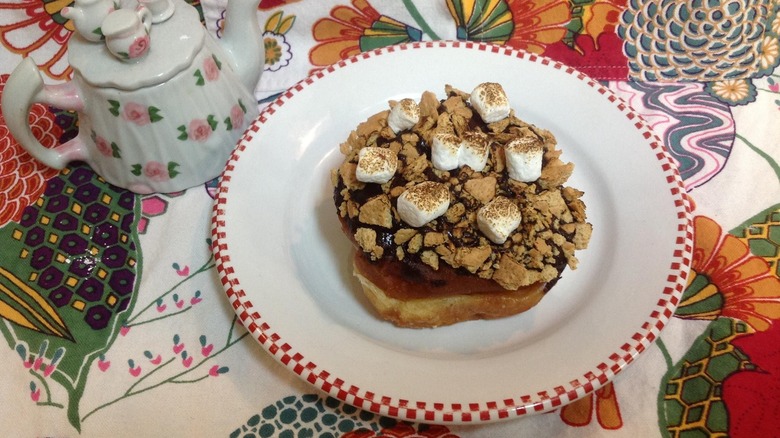 S'more donut on a plate on a floral tablecloth