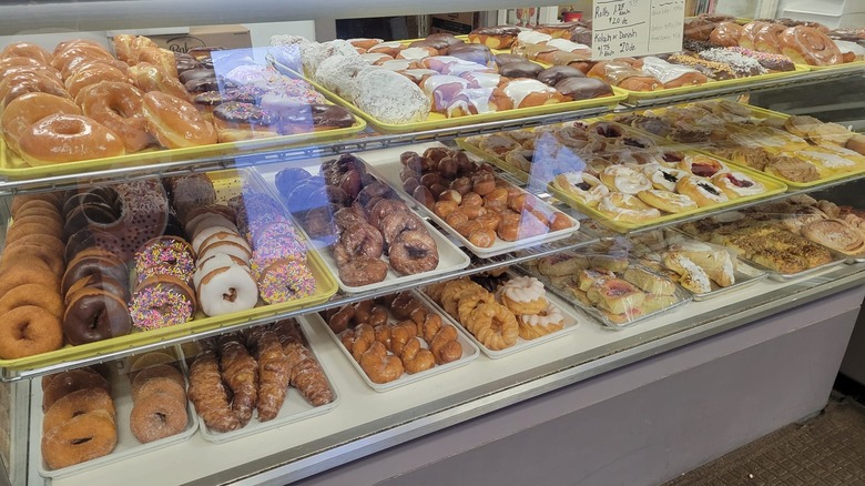 Bakery display case filled with different donuts