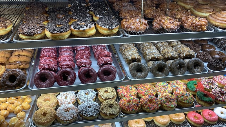 Fully stocked bakery case with various donuts