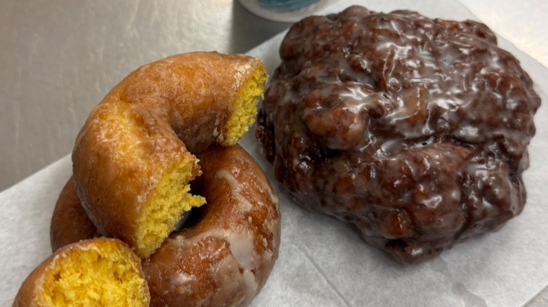 Two glazed cake donuts and a glazed fritter