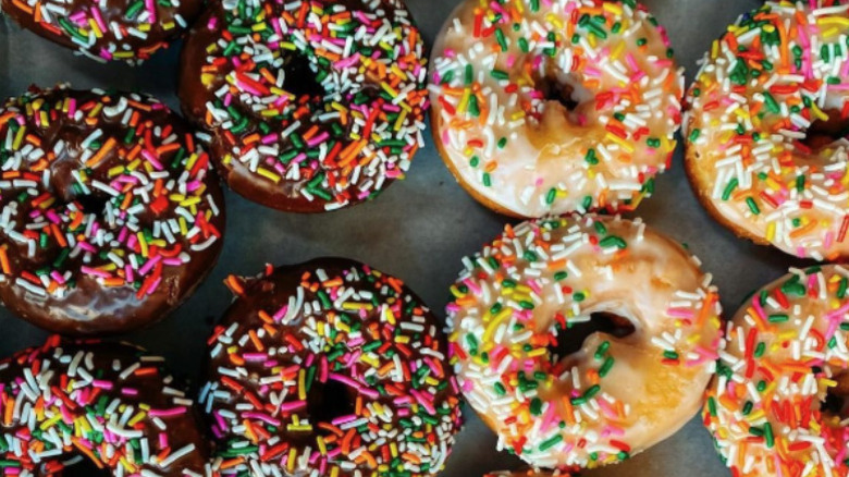 Selection of sprinkled chocolate and vanilla donuts