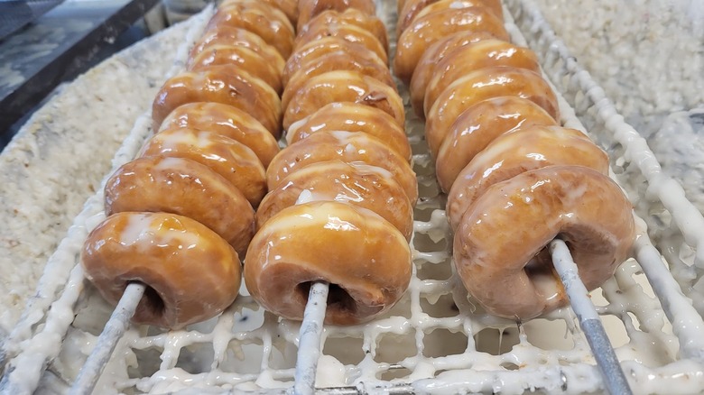 Rows of freshly glazed donuts