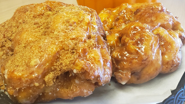 Two large glazed fritters on a plate