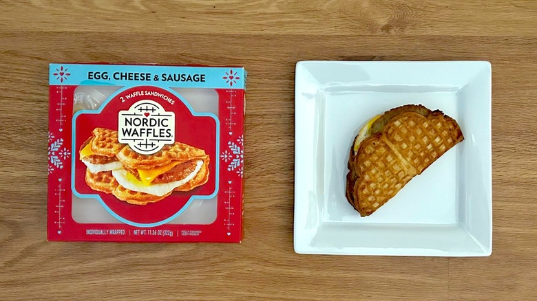 Package and cooked Nordic Waffles Egg, Cheese, & Sausage on square white plate