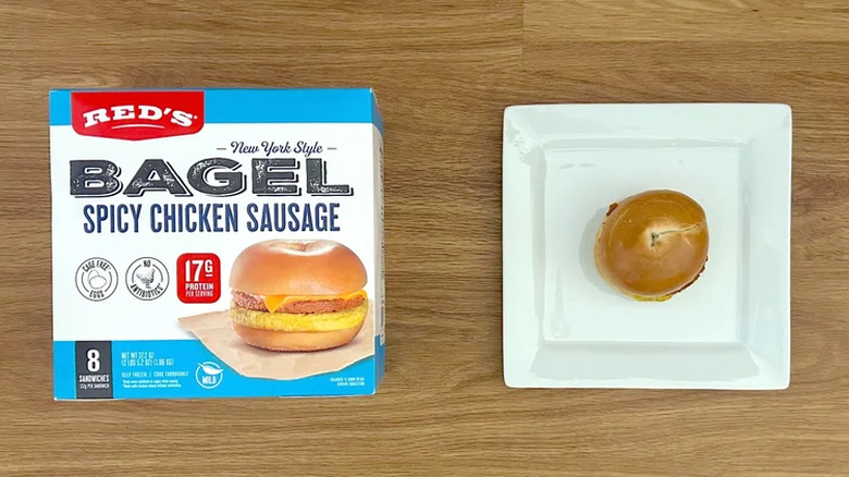 Package and cooked Red's New York Style Bagel Spicy Chicken Sausage on square white plate