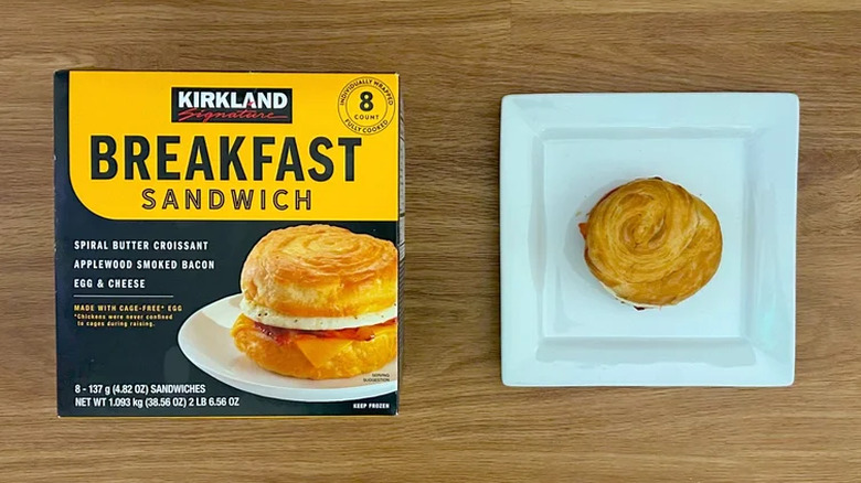 Package and cooked Kirkland Signature Breakfast Sandwich on square white plate