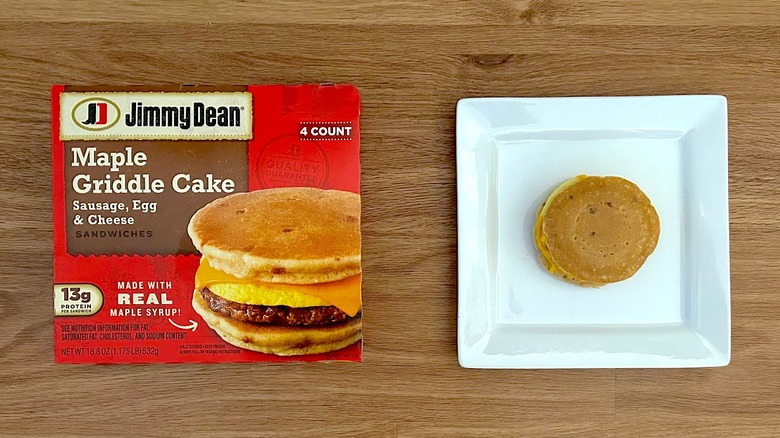 Package and cooked Jimmy Dean Maple Griddle Cake Sausage, Egg, & Cheese on square white plate