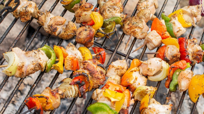 meat and veg kebabs on a grill