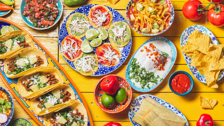 A variety of Mexican foods on a wooden table