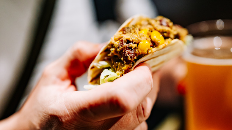 Holding a Mexican taco