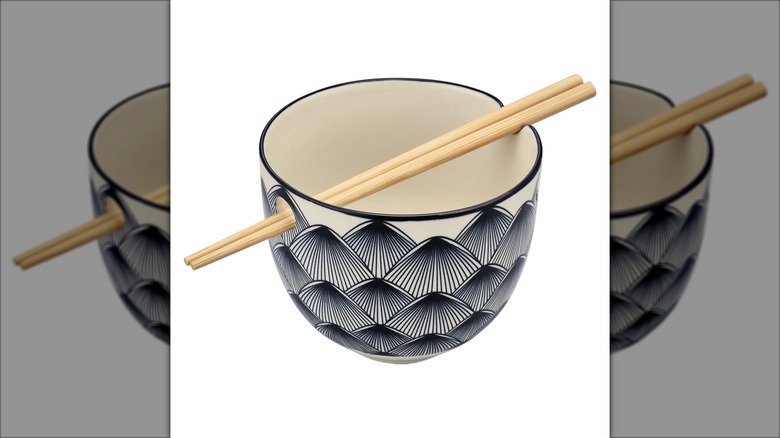 gray and black noodle bowl with chopsticks
