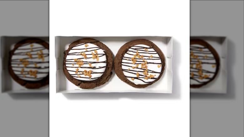 two smores cookies with white frosting in white box