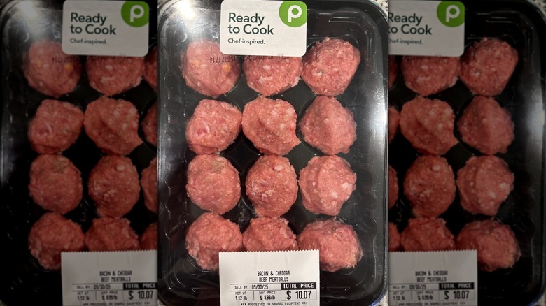 a dozen publix raw meatballs on black tray