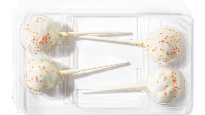 white frosted pumpkin cake pops in clamshell package