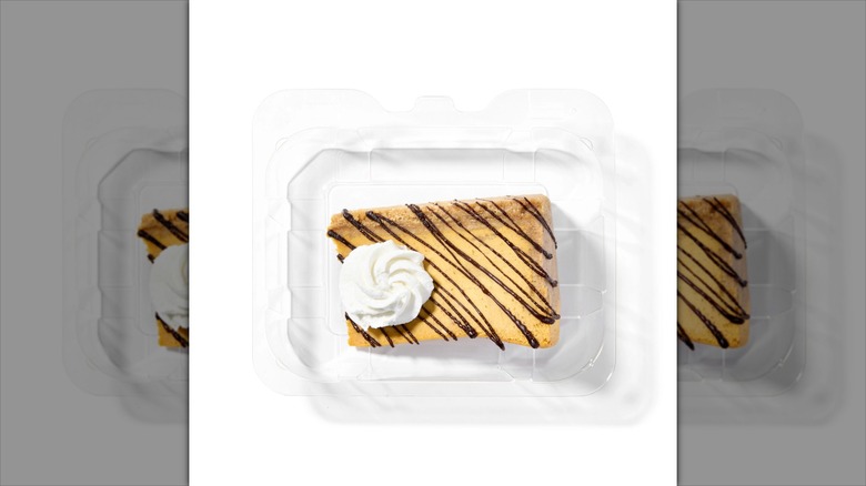 enormous cheesecake chunk with whipped cream