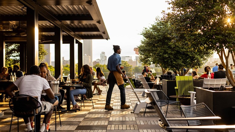 People enjoying the rooftop bar at 9 Mile Station in Georgia