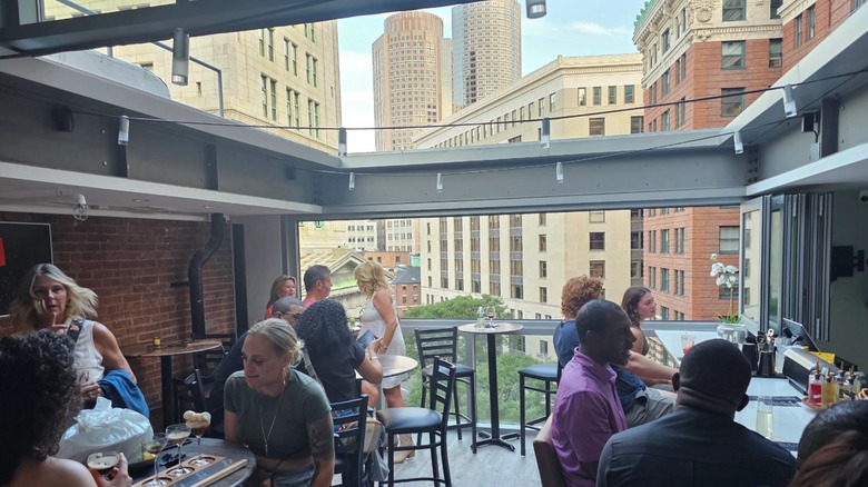 People inside the Apex Rooftop Bar and Lounge in Massachusetts