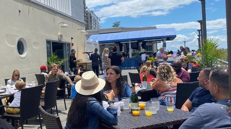 People enjoying the rooftop bar at Sign of the Whale in Connecticut