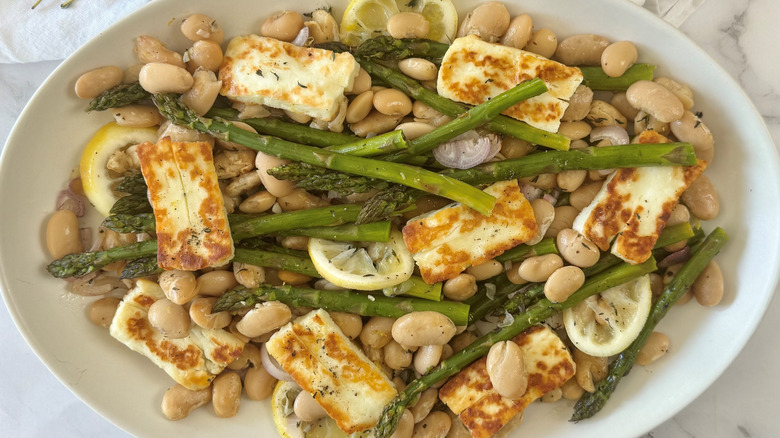 asparagus, beans, and cheese on a white plate