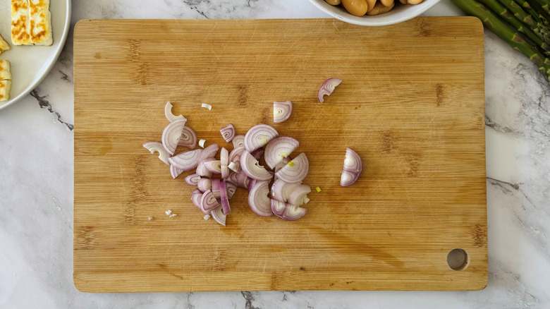 chopped shallots on a wooden board