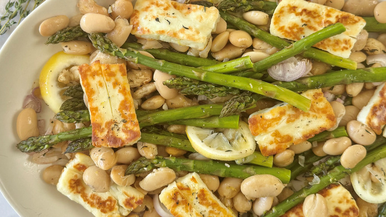 asparagus, beans, and cheese on a white plate