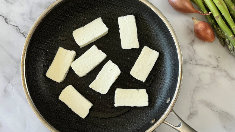 Halloumi cheese slices in pan