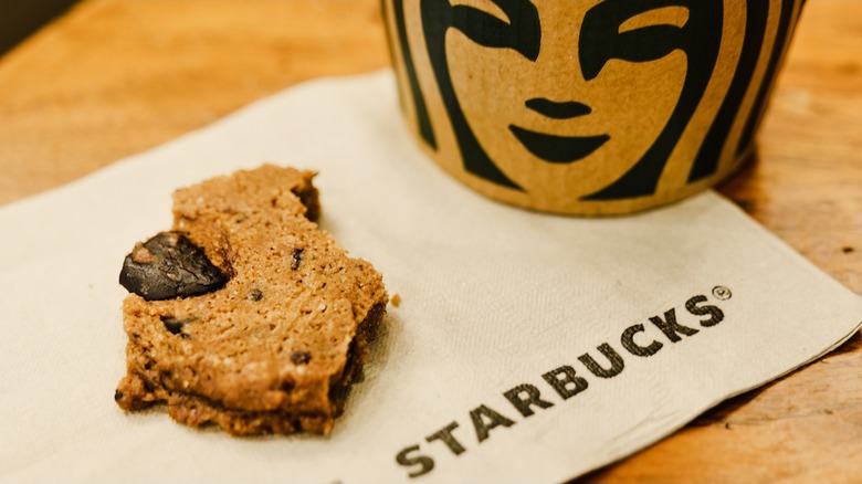 mostly-eaten starbucks chocolate chip cookie on a napkin