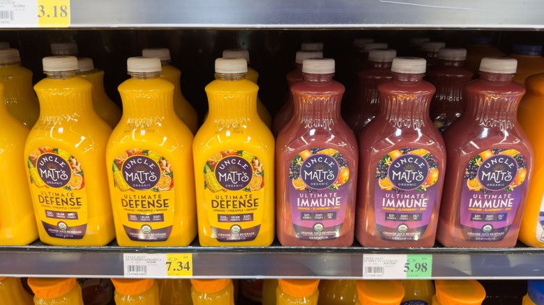 uncle matt's juices arranged on supermarket shelf