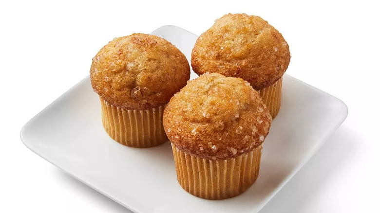 Three banana mini muffins on a white plate