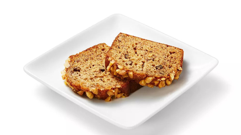 Two pieces of banana nut cake on white plate