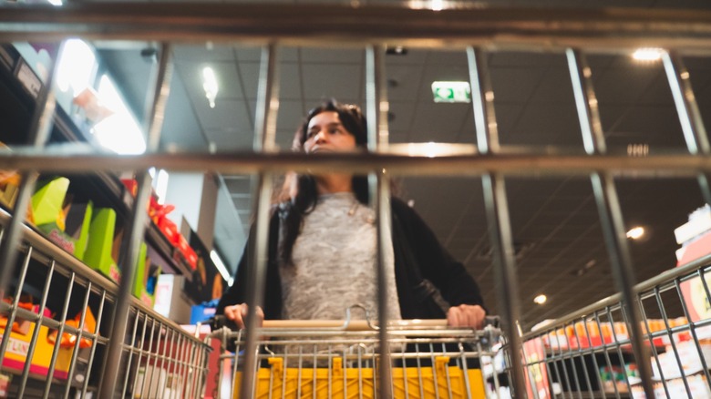 woman pushes shopping cart