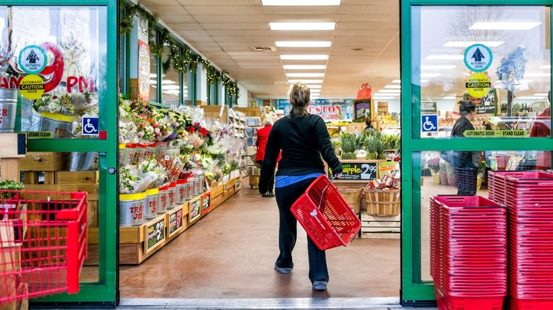 customer enters trader joe's store with red basket