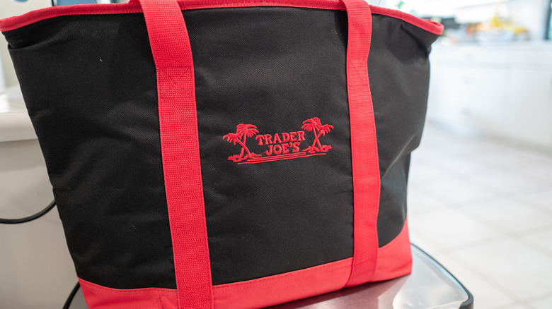 Closeup of black and red embroidered Trader Joe's insulated bag