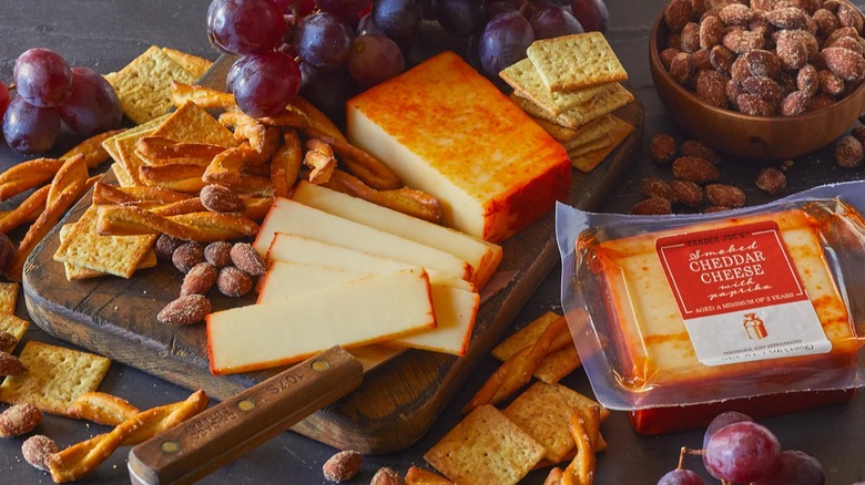 cheese on charcuterie board with crackers and fruit