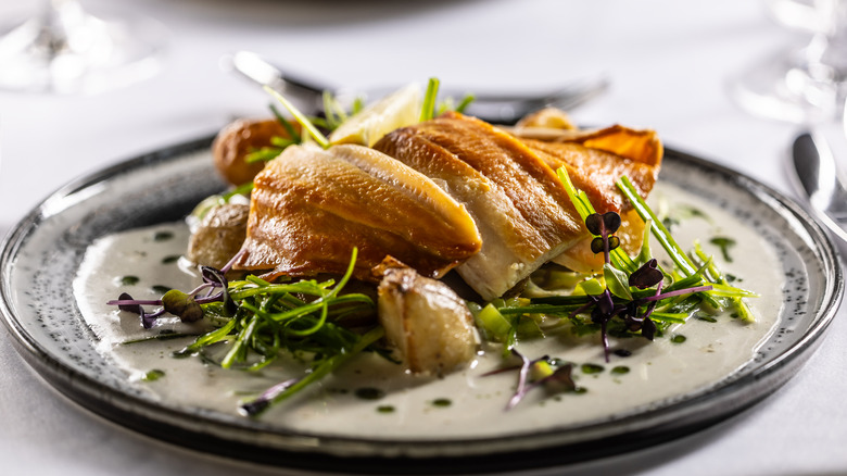 A dressed plate of cooked trout